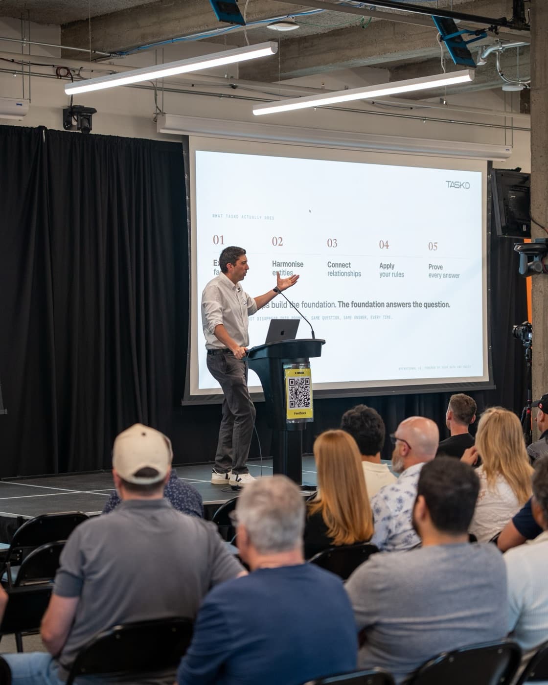 AI founder presenting their startup on stage at a Spark AI Showcase Night